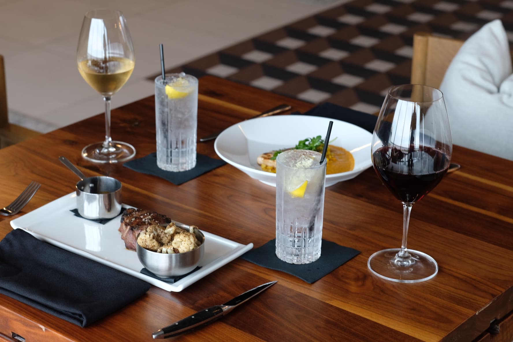 A plated dinner with wine and cocktails