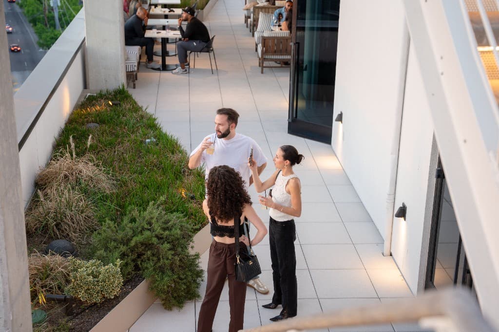 Guests with cocktails on the rooftop terrace at Retreat